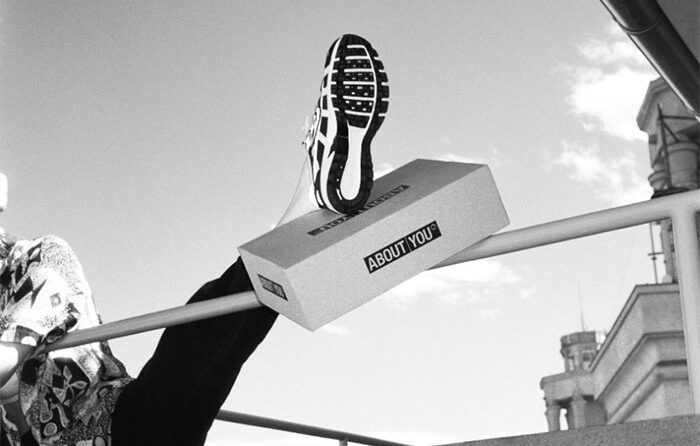 Person showing shoe holding a shoe box