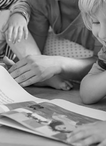 child joyfully looking at a book