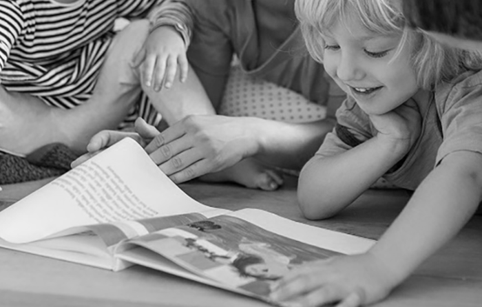 child joyfully looking at a book
