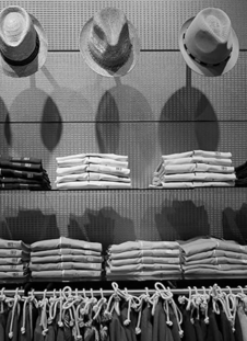 hats and clothing on shelves in a shop