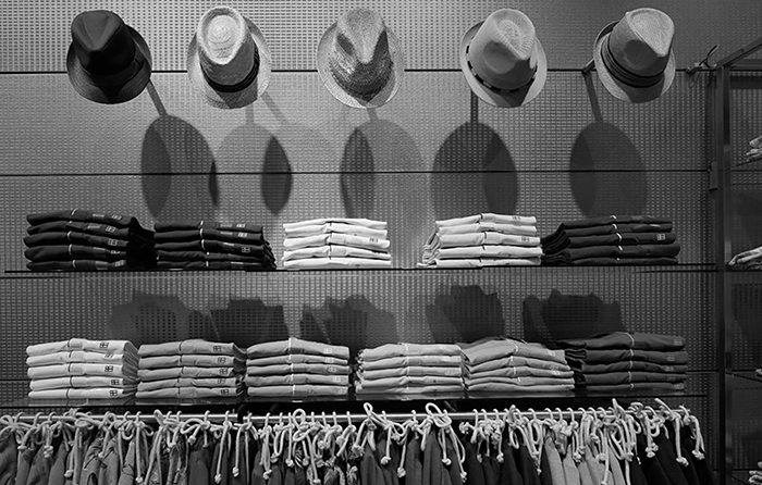 hats and clothing on shelves in a shop